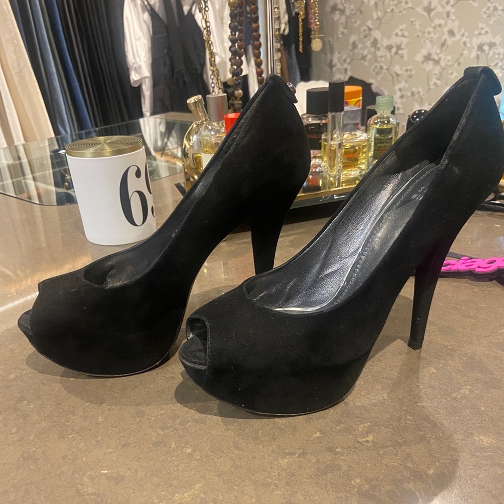 Stuart Weitzman black suede platform peep toe stilettos.